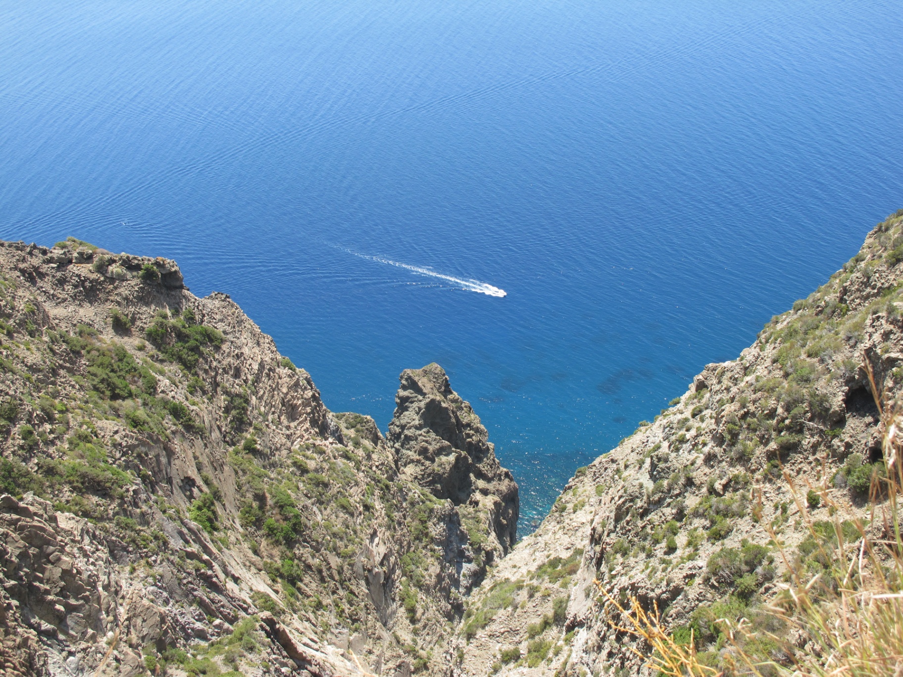 Salto la Vecchia cliffs plunging into deep blue sea