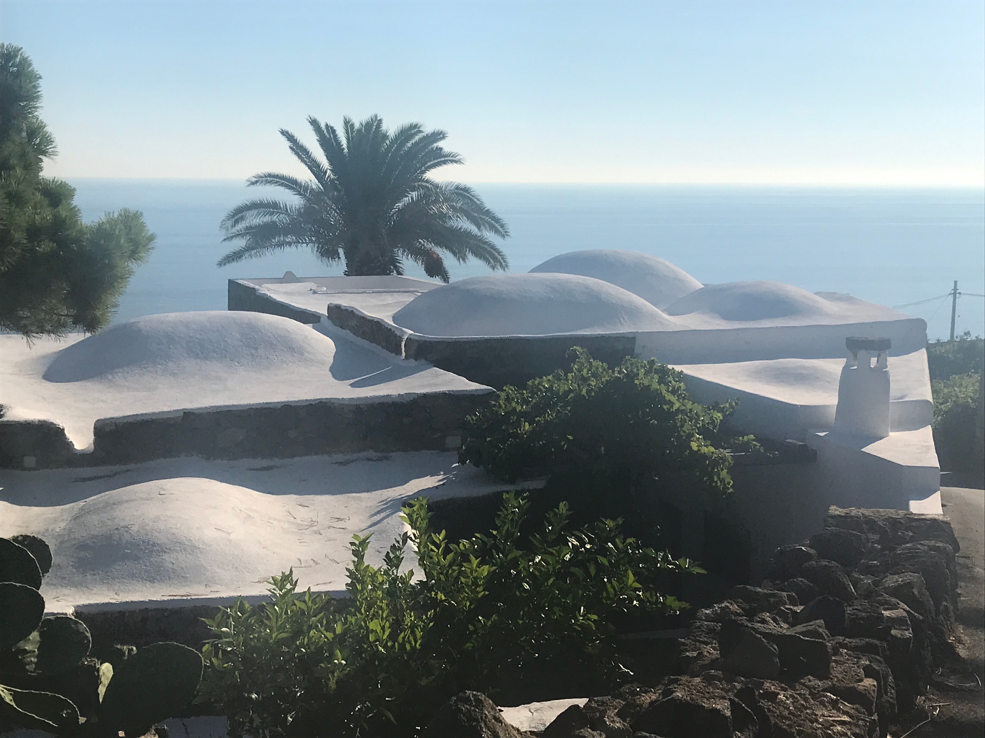 White-domed vaulted roofs of the dammuso overlooking the sea
