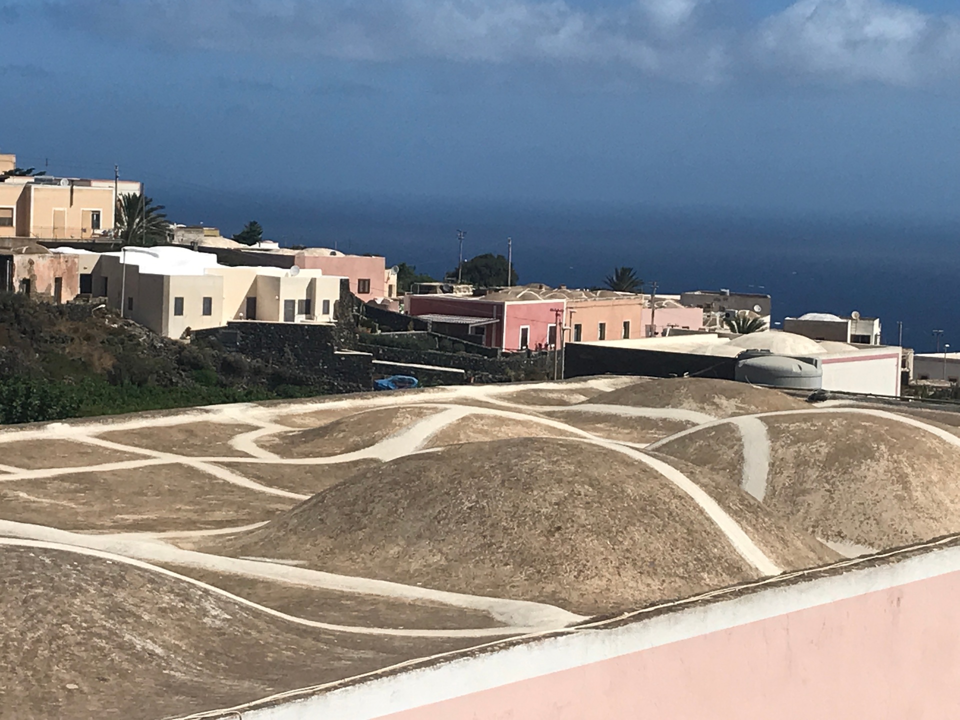 Undulating white-painted dammuso roofs at Tracino