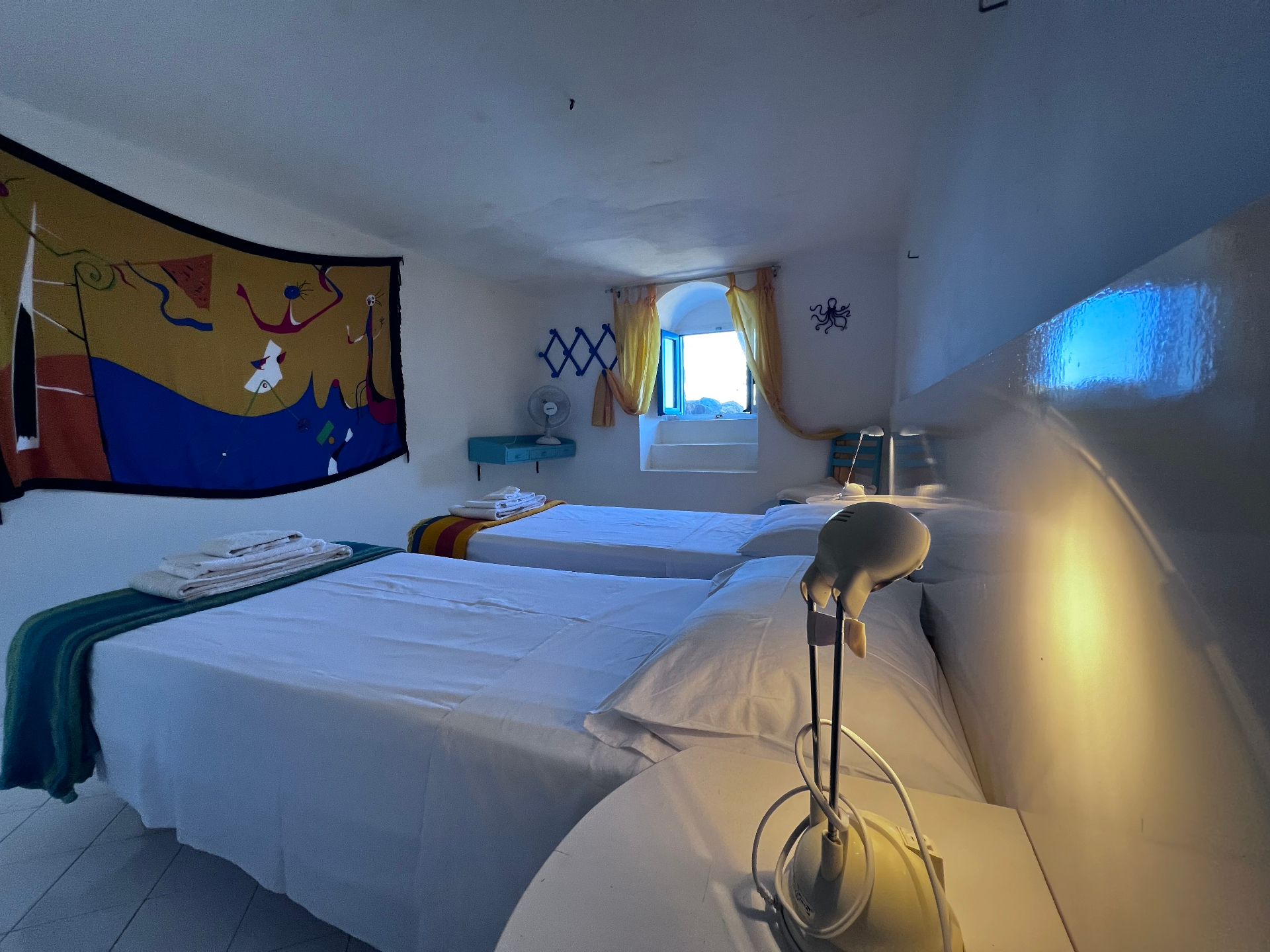 East Room interior with colorful tapestry and twin beds